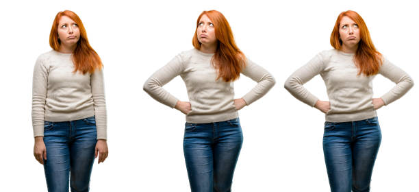 Young Beautiful redhead woman doubt expression, confuse and wonder concept, uncertain future