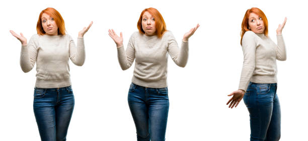 istock Young Beautiful redhead woman doubt expression, confuse and wonder concept, uncertain future shrugging shoulders 1042021858