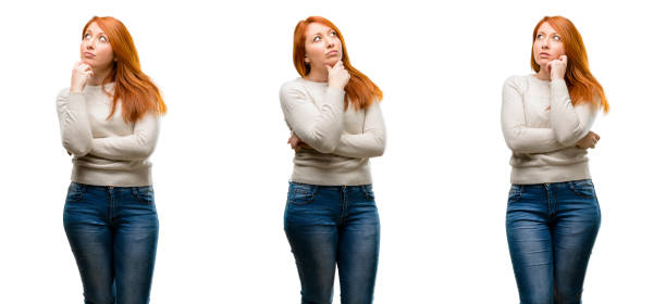 istock Young Beautiful redhead woman thinking and looking up expressing doubt and wonder 1042021948