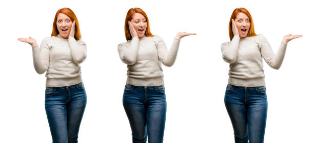 istock Young Beautiful redhead woman holding something in empty hand 1042022090