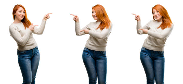 istock Young Beautiful redhead woman pointing away side with finger 1042024882