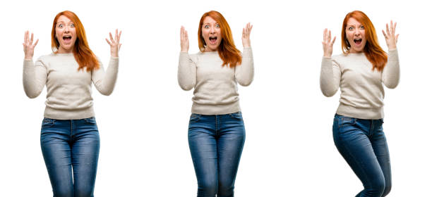 istock Young Beautiful redhead woman happy and surprised cheering expressing wow gesture 1042024950