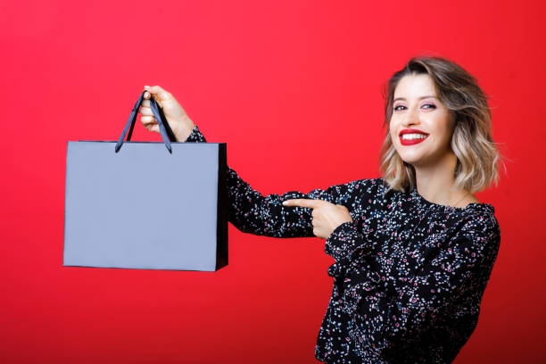 istock Young woman showing buy in package 1042025590