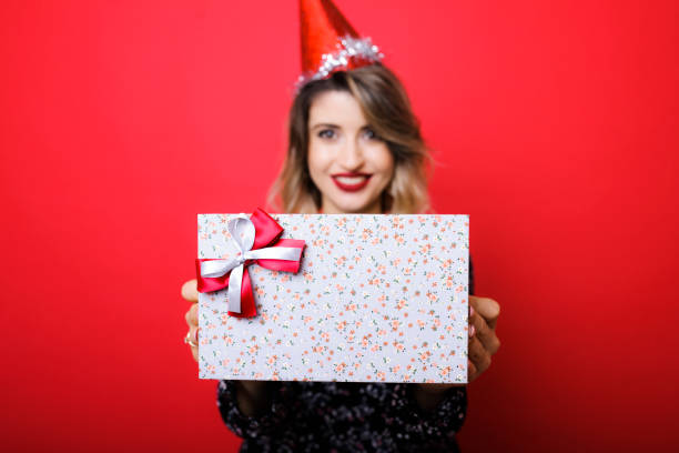 istock Young woman holding box with gift 1042025674
