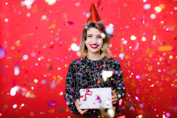 istock Young woman standing under confetti 1042025686