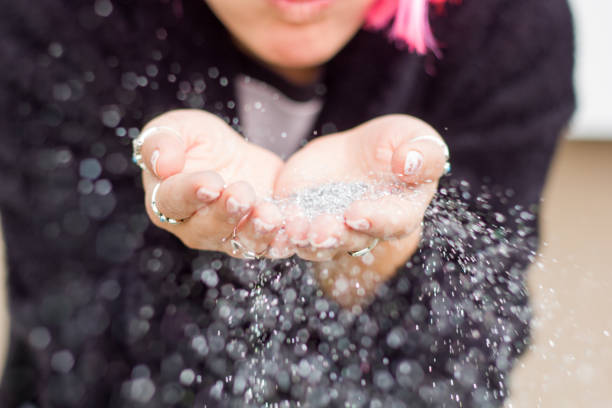 portrait of a woman in pink wig with silver sequins in her hands