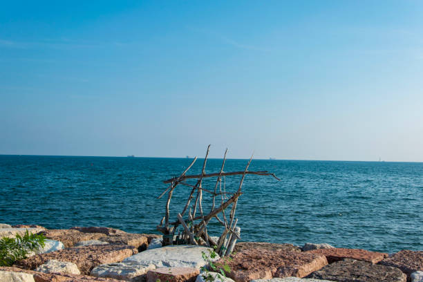 Improvisation of a wooden sun cover, near by the Seaside on a Rocky Pier