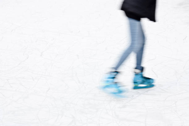 istock Young person ice skating, legs in motion blur 1042050436