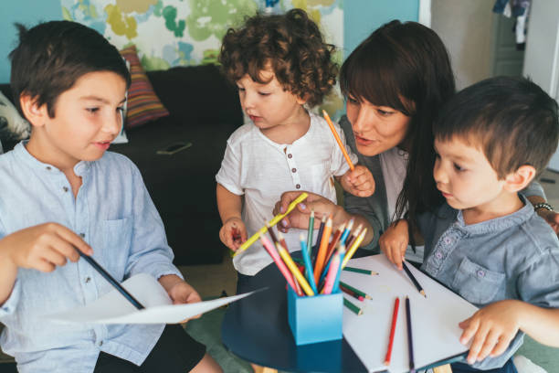 istock Mother and sons drawing together 1042058918