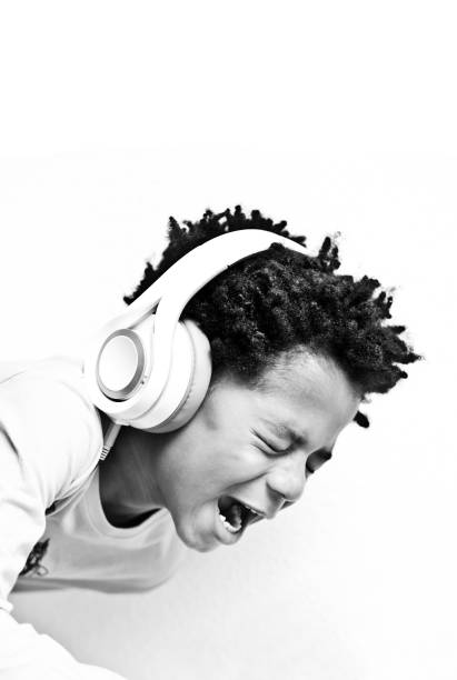 istock Little Boy Enjoying His Music (Monochrome / Black And White) 1042063120