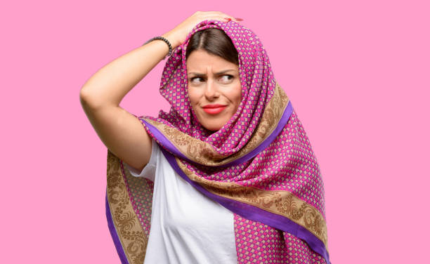 istock Young arab woman wearing hijab doubt expression, confuse and wonder concept, uncertain future 1042065766