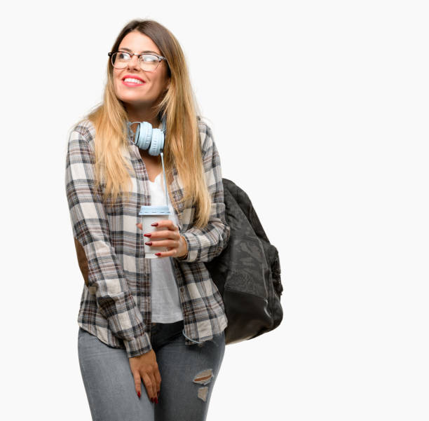 istock Young student woman with headphones and backpack thinking and looking up expressing doubt and wonder 1042066116