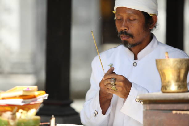 Bali, Indonesia - March 02, 2011: a procession of people сarrying religious offerings on the Seminyak beach for Melasti festival in Bali