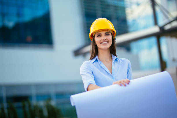 istock Woman holding blueprint and smiling 1042112804