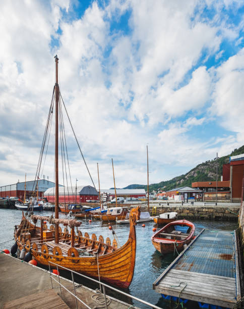 Old Town pier with sailing ship in Bergen, Norway Old Town pier with old boats and sailing ship. Historical district of the Bryggen - Hanseatic wharf in Bergen, Norway. bergen norway stock pictures, royalty-free photos & images