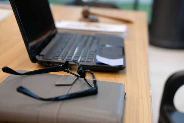 istock eyeglasses computer on wood office desk near window. wokring space concept 1042129630