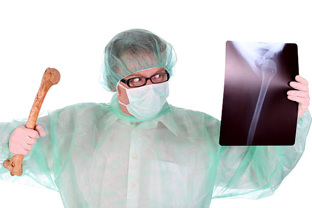 surgeon with xray and bone stock photo