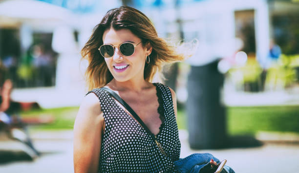istock Young beautiful woman walking down the streets 1042149290