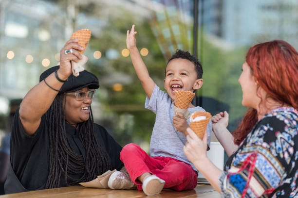 istock Two moms eat ice cream with their three-year old son 1042152846