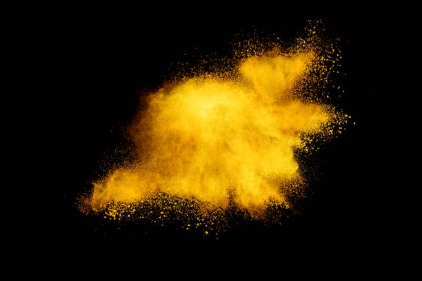 istock Yellow powder explosion on black background. Colored cloud. Colorful dust explode. Paint Holi. 1042154034
