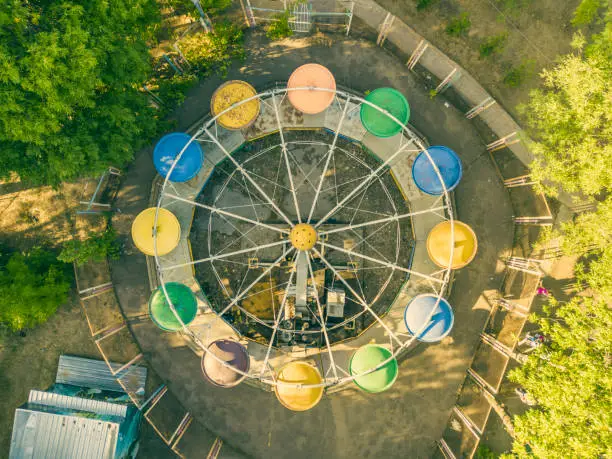 Photo of aerial top view of city park caorusel with happy children on summer holidays f