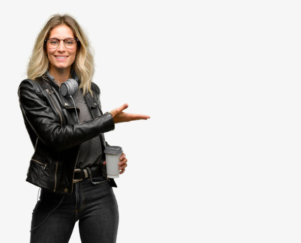 istock Young student woman with headphones holding something in empty hand 1042158218