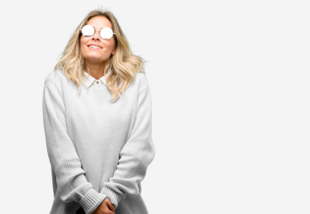Young beautiful woman using smartphone thinking and looking up expressing doubt and wonder