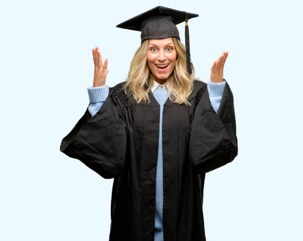 istock Young graduate woman happy and surprised cheering expressing wow gesture 1042160934