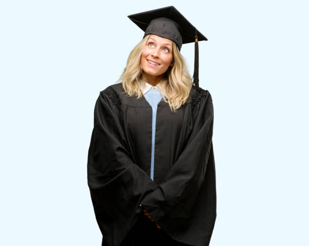 istock Young graduate woman thinking and looking up expressing doubt and wonder 1042161020