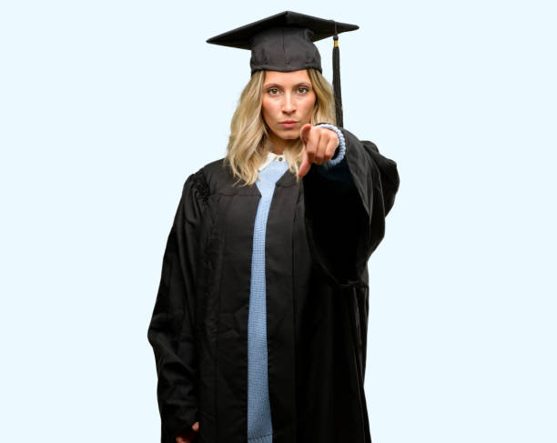 istock Young graduate woman pointing to the front with finger 1042161064