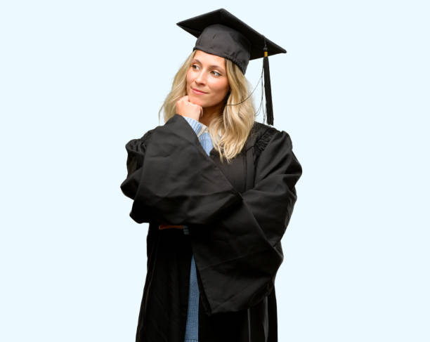 istock Young graduate woman thinking and looking up expressing doubt and wonder 1042161084