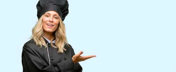 istock Beautiful cook woman chef holding something in empty hand 1042161390