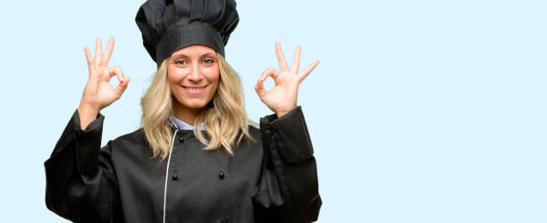 istock Beautiful cook woman chef doing ok sign gesture with both hands expressing meditation and relaxation 1042161414