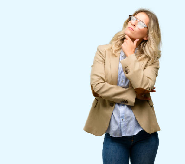 Young beautiful woman thinking and looking up expressing doubt and wonder