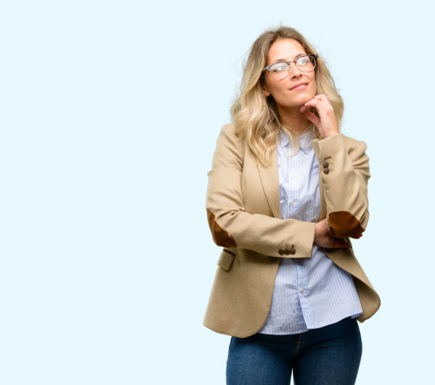 Young beautiful woman thinking and looking up expressing doubt and wonder