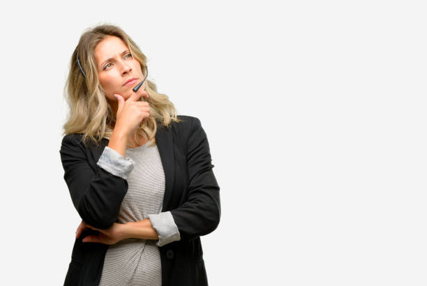 istock Young woman operator from call center thinking and looking up expressing doubt and wonder 1042162136