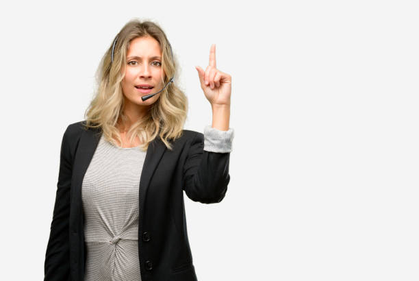 istock Young woman operator from call center happy and surprised cheering expressing wow gesture pointing up 1042162166