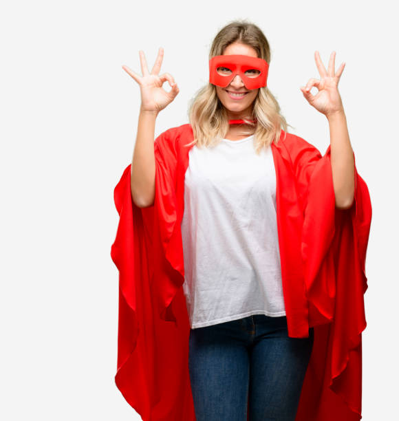 istock Young super hero woman wearing cape doing ok sign gesture with both hands expressing meditation and relaxation 1042165048
