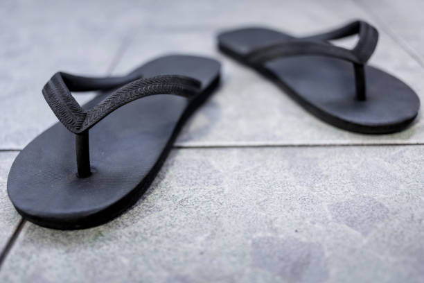 istock Black sandals on the floor background 1042181562
