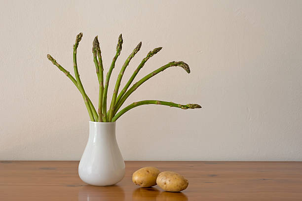 Still life with asparagus and potatoes stock photo