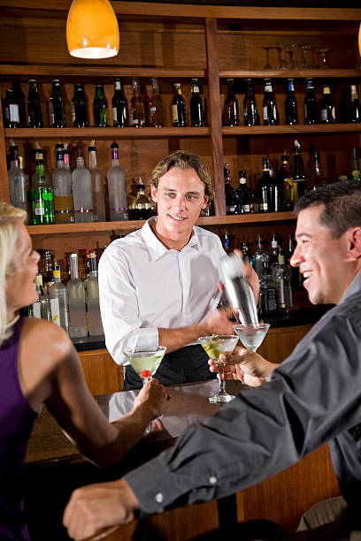 istock Friendly bartender mixing drink chatting with couple in restaurant bar 104221497