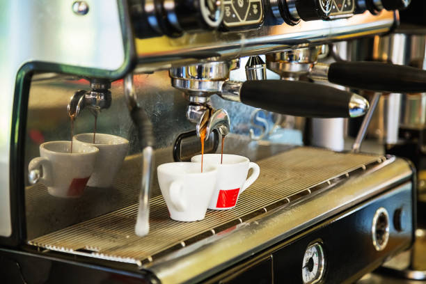 istock Close-up of espresso pouring from coffee machine. 1042228540