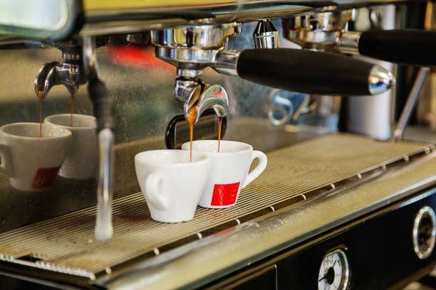 istock Close-up of espresso pouring from coffee machine. 1042228616
