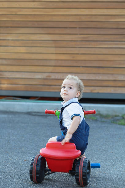 istock Two years old boy riding trycycles outdoor 1042229084