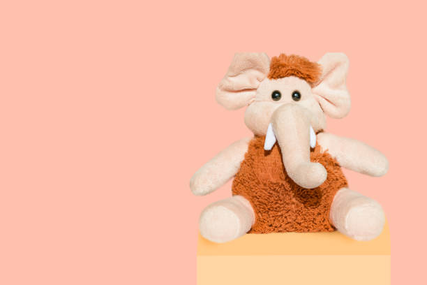 istock Soft toy beige with brown wool mammoth elephant isolated 1042229374