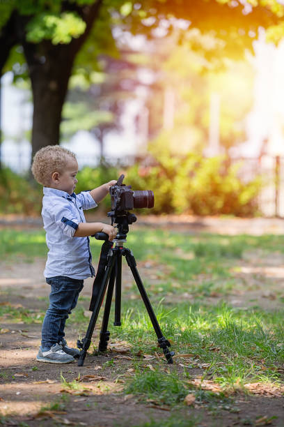 istock A two years old boy is photographer. 1042230188