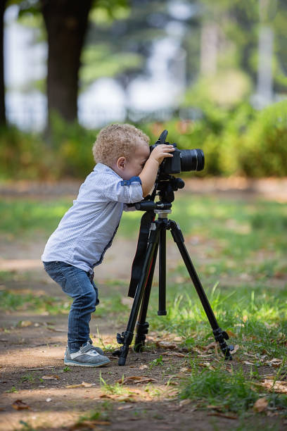 istock A two years old boy is photographer. 1042232256