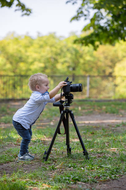 istock A two years old boy is photographer. 1042232474