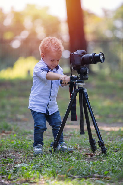 istock A two years old boy is photographer. 1042233492