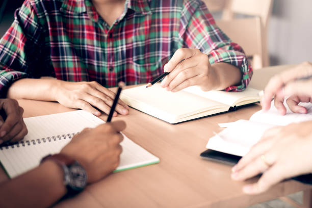 istock Students are helping to brainstorm about homework in the library. 1042236378